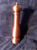 Full height side view of the Trudeau copper finish pepper mill showing its shape and finish.