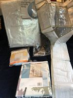 Overview of all items in lot: shower curtain still in package, 24 shoe rack, pop-up hamper, clear hanging dress bag.