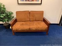 Front view of the brown velour loveseat showing the two seat cushions and wooden frame.