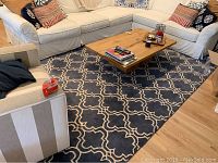 Living room view showing full rug under coffee table and seating