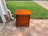 Photo of one bedside table showing two drawers and the top surface