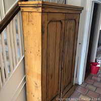 Front and side view of the pine cabinet showing overall shape and finish