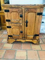 Front view showing three doors with metal hinges and latch