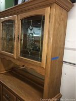 Side view showing profile and oak construction of buffet cabinet.