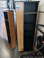 Five storage units made of wood veneer and black interiors, tallest measuring approximately 19x19x52 inches.
