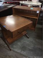 Photo showing wooden bookshelf and KROEHLER end table side by side.