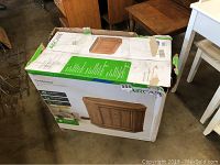 View of damaged original box showing product name and image of the humidifier designed like a credenza