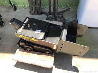 Side view of the FlexAir 18k pin box showing overall shape, black paint, FlexAir branding, and pneumatic fitting capped on top.