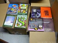 Two open boxes showing various DVDs including animated movies and documentary sets.