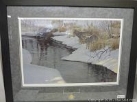 Full view of framed print showing wolves by a creek in winter