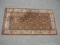 Top-down image of rectangular vintage carpet showing full pattern and border detail