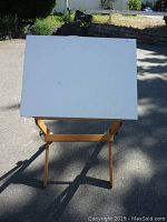 Front view showing white drawing surface and wooden frame.