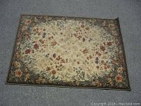 Full top view of rectangular floral area rug laid flat on surface