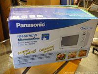 Wide shot of the Panasonic microwave oven box with model and features visible.