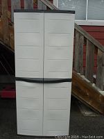 Front closed view of the Workforce plastic outdoor storage cabinet showing four panel doors with black trim handles.