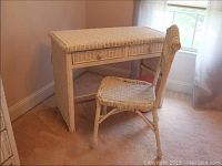 Wicker desk and chair set in corner of room, showing overall view, desk with two drawers and wicker woven design