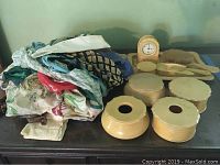 View of the entire vanity set and pile of scarves, showing yellow ceramic pieces and colorful fabric scarves.