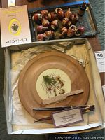 Photo showing the rectangular metal tray with Egyptian design, small wooden jugs with striped patterns, small woven baskets, and a box of Olivia Care bath soap.