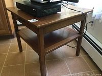 Full view of the Imperial Furniture wooden end table with a device placed on the top.