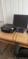 Epson XP 630 printer and Dell Ultrasharp monitor on wooden table, showing both items together.
