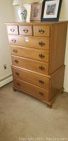 Full view of the Beals tallboy dresser showing eight drawers and overall condition.