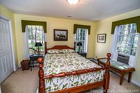 Front view of assembled wooden queen bed frame with mattress installed