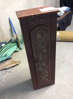 Side-front view of the vintage jelly cabinet showing painted floral decoration and inscription on the door.