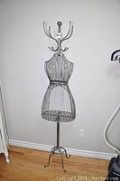Front view of the full height wireframe metal mannequin hat rack showing the upright hooks and detailed wire torso.