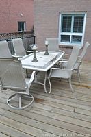 Full deck view of rectangular table with six chairs and two candle holders