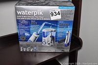 Original new in box Waterpik Ultra Cordless Water Flosser with detailed product image on package.