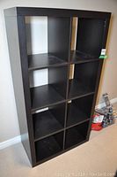 Front view of the bookshelf with eight cubed compartments shown empty.