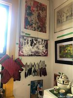 View of all three abstract paintings by Alex Hare hung on a wall, largest at top, medium below it, smallest at bottom.
