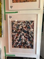 Front view of the framed original abstract art by Alex Hare, showing abstract mix of colors and brushstroke patterns within a white frame and matting.