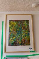 Full view of framed abstract painting with visible texture and layered colors dominated by greens and yellows.