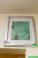 Framed abstract art piece with silver frame and white mat, size 15x12, mounted on wall