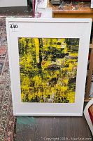 Full view of framed abstract painting featuring a yellow and black textured design with hints of white and red, signed by Alex Hare if visible.