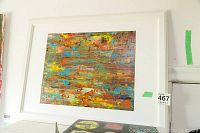 Full view of the framed abstract painting featuring a color palette of blues, yellows, oranges, and reds with a white frame and matte.