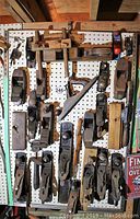 Front view of pegboard mounting showing 26 hand planes including bench planes, curved sole, box scraper and horned plane