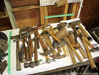 Overall view of assortment of hammers and mallets on table