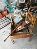 Antique wooden Jubilee washing machine with wringer roller and crank handle, showing general condition and size.
