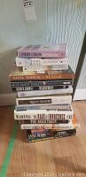 Stack of novels showing multiple titles including Anita Shreve Rescue, Janet Dailey Lone Calder Star, Dean R. Koontz Hideaway, and Blood Memory by Greg Iles.