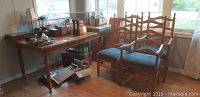 Wooden dining table with blue cushioned chairs grouped side by side