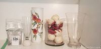 Photo of the five vases including Royal Worcester Evesham pattern vase and clear glass vases in different styles.