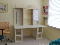 Photo showing the full Ikea modular desk in a room with a window and two chairs nearby.