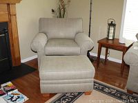 Full front view of chair with ottoman in room setting