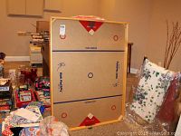 Full view of the Nok Hockey game board showing playing surface, game markings and accessories around the edges.