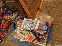 Assorted paper napkins and plastic partyware including serving platters and trays in various colors and patterns