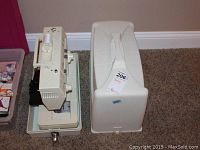 Singer Merritt 4525 sewing machine with hard protective carrying case on carpeted floor.