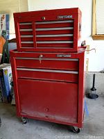 Front view of assembled top chest and bottom cabinet on casters