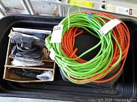 Top view of garden cart with power cords and a Black & Decker sander in box